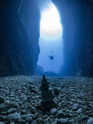 The impressive canyon that connects the Inland Sea on Gozo with the open ocean. A small tower of stones has been stacked by another diver.